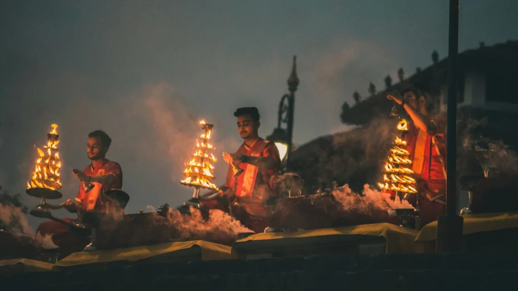 Priests performing the grand Ganga Aarti with multi-tiered brass lamps at Dashashwamedh Ghat, Varanasi during the Shivratri festival.