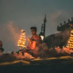 Priests performing the grand Ganga Aarti with multi-tiered brass lamps at Dashashwamedh Ghat, Varanasi during the Shivratri festival.